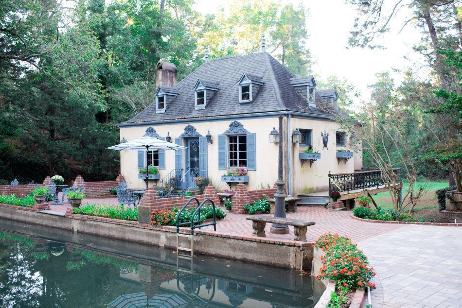 A house with a pond and garden in the middle of it