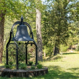 A bell in the middle of a park