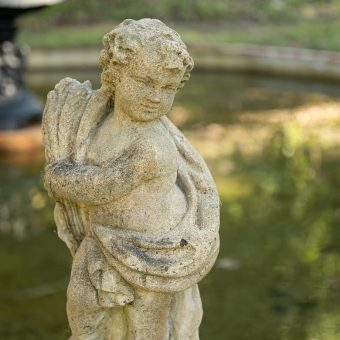 A statue of an angel holding a wreath.