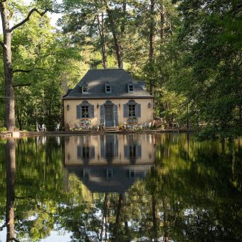 A house is shown in the middle of a lake.