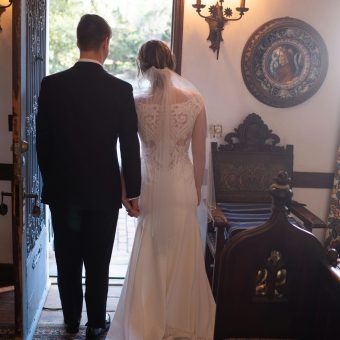 A bride and groom walking into their wedding ceremony.