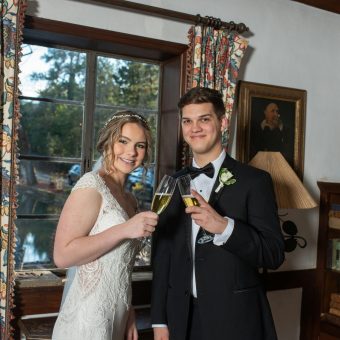 A man and woman holding champagne glasses in their hands.